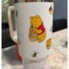 Funny Winnie the Pooh mug featuring honey jar and bees, perfect gift for Pooh fans.
