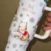 Cute bear and floral design mug with Stanley logo, perfect for peace-themed decor.