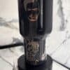 Stylish black thermos with peace and modern graphic design.