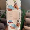 Colorful Disney characters themed reusable travel mug with Mickey and Pluto illustrations.