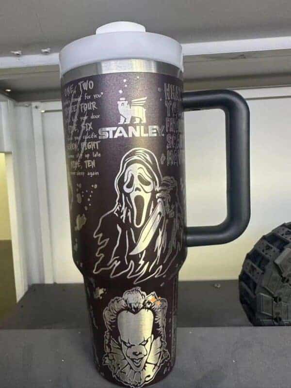 Decorative travel mug with horror and street art designs.