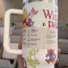 Cute Winnie the Pooh tea travel mug with playful characters and bees.