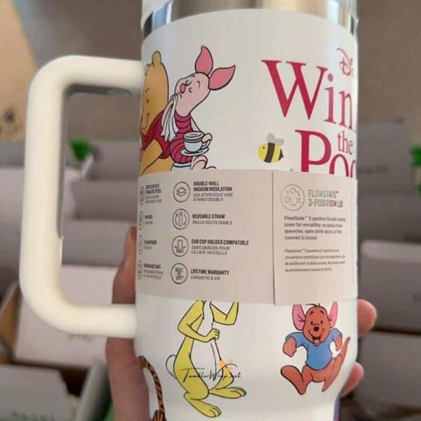 Cute Winnie the Pooh tea travel mug with playful characters and bees.