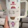 Durable insulated tumbler featuring playful animal illustrations and floral design for hydration.