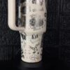 Decorative travel mug with peace-themed illustrations and stickers.