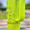 Colorful peace-themed drink tumbler with cartoon characters and message.