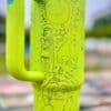 Colorful Shrek-themed tumbler with whimsical designs.