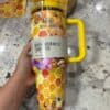 Colorful honeycomb and bee design, kid-friendly water bottle for hydration.