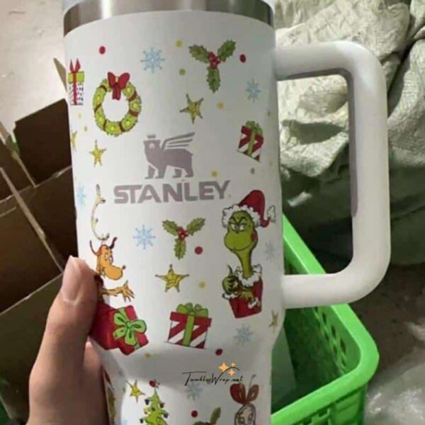 Decorative holiday travel mug with Christmas motifs and Stanley branding for festive season.
