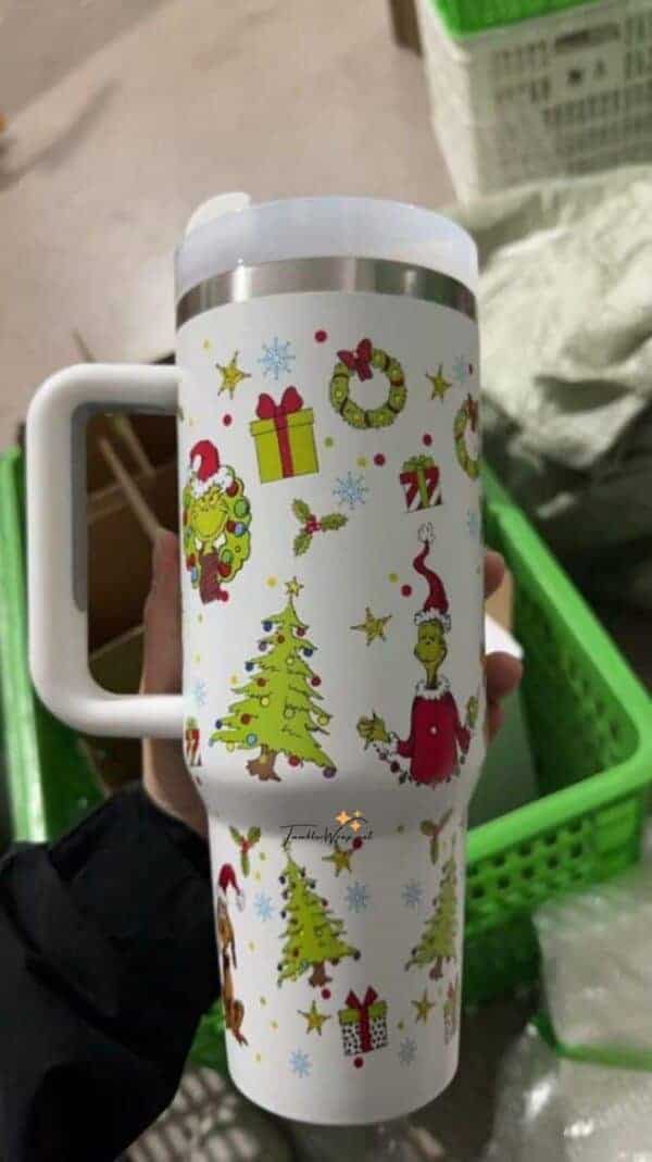 Festive holiday travel mug with Christmas trees, Santa, Wreath, and gifts.