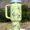 Cute cartoon frog wearing a Santa hat drinking from a traveling mug.