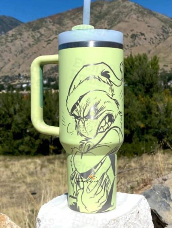 Cute cartoon frog wearing a Santa hat drinking from a traveling mug.