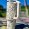 Stylish insulated tumbler with peace symbols and floral patterns, perfect for serenity lovers.