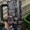 Vibrant mug with mountain, wolf, diamond, and heart designs.