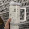 Festive holiday themed stainless steel mug with Santa and reindeer design.