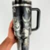 Travel mug featuring Venom graphic with monster illustrations and handle for hot beverages.