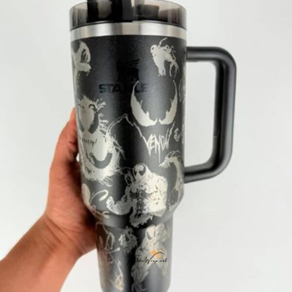 Travel mug featuring Venom graphic with monster illustrations and handle for hot beverages.
