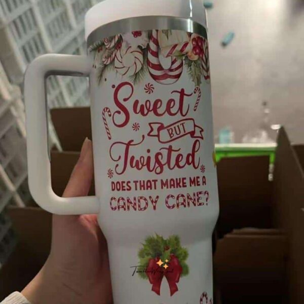 Festive Christmas coffee mug with candy cane and holiday decor.