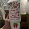 Decorative holiday-themed coffee mug with festive message.