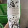 Vibrant Halloween-themed reusable tumbler with skull, skeleton, and spooky motifs.