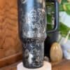 Detailed Peace SVG design on black travel mug.