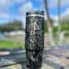 Insulated travel tumbler with Chingon design and artistic floral pattern.