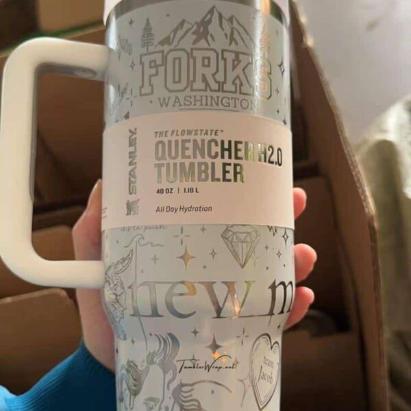 White insulated tumbler with mountain and star illustrations.
