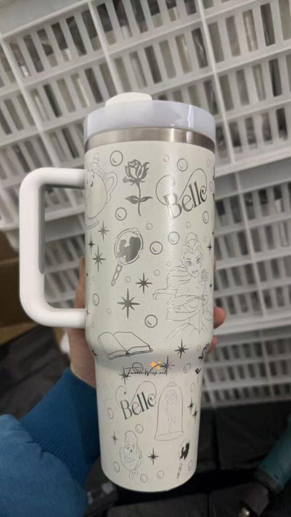 White insulated travel mug with Disney princess and magic-themed illustrations.