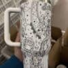 Coloring-inspired peace sign thermos with whimsical designs.