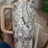 Coloring mug with celestial and floral patterns for relaxation and creativity.