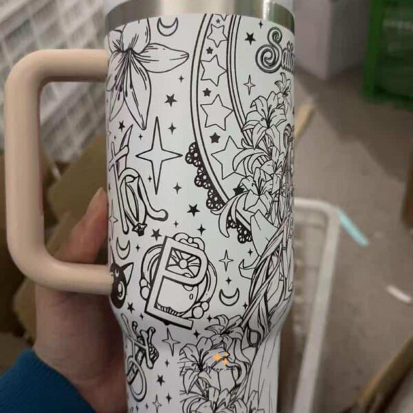 Coloring mug with celestial and floral patterns for relaxation and creativity.