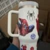 Decorative Spider-Man themed travel mug with Marvel character graphics.