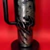 Black travel mug with gothic skeleton illustration, ideal for Halloween.