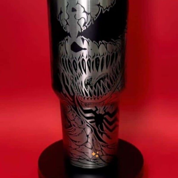 Stainless steel skull-themed tumbler with bold black and white graphics, perfect for fans of horror art.