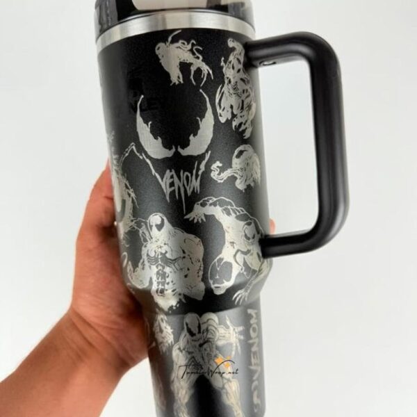 Black travel mug with dragon and skull designs.