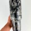 Decorative metal tumbler with horror-themed skull and creature designs.