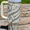 Stylish travel mug with Salem-themed Halloween designs and symbols.