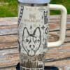 Custom engraved stainless steel travel mug with dog illustrations and celestial designs.