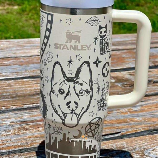 Custom engraved stainless steel travel mug with dog illustrations and celestial designs.