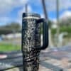 Stylish black and white peace-themed insulated tumbler with floral and butterfly designs.